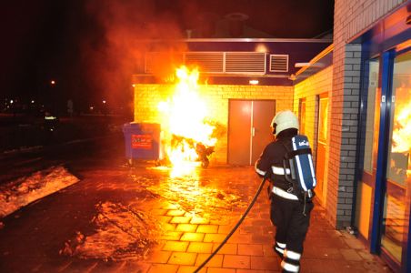 Container staat in brand tegen winkelpand aan de Prof. De Savornin Lohmanpark Waalwijk