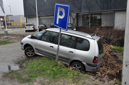 Bestuurder wil auto netjes in een parkeervak zetten in Waalwijk, maar rijdt een sloot in